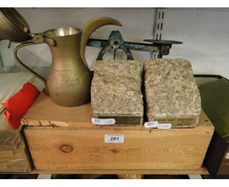 Bookends made from granite of London Bridge, a scale, brass jug and a box of building bricks.