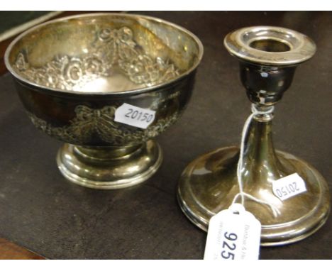 A embossed silver bowl and a silver candlestick