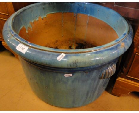 A blue glazed circular ceramic planter.