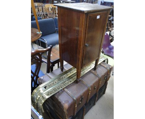2 Vintage travelling trunks, a brass fender and a pot cupboard.