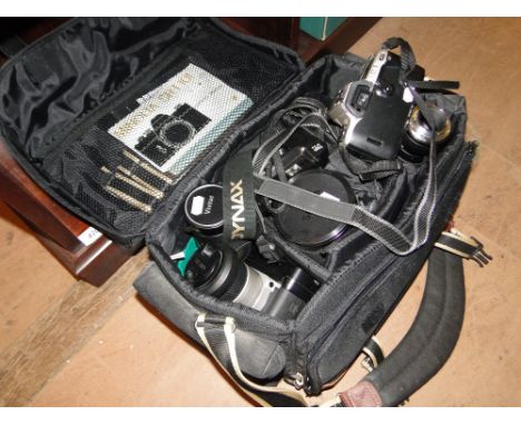A digital camera, lenses in travelling case, etc.