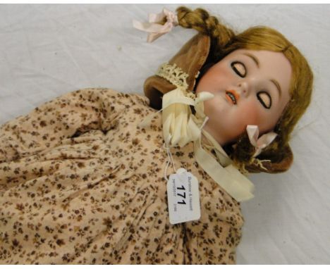 A German K&R Vintage porcelain headed doll with jointed composition limbs.