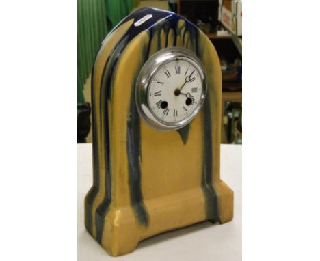 A continental pottery mantel clock with 2-train movement.