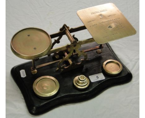 A set of Victorian brass letter scales engraved with postage rates, and complete with weights.