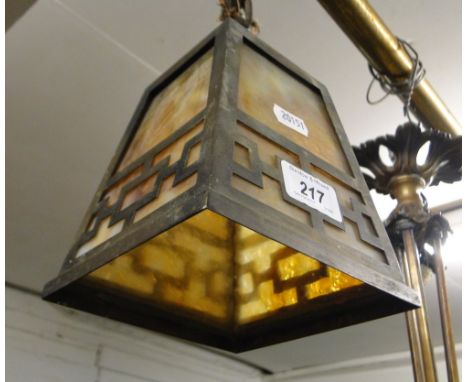 A small square light shade with metal mounts.