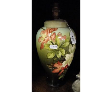 A pottery lamp with floral decoration.