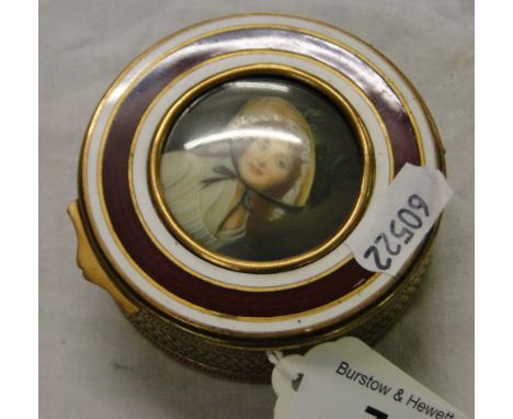 A gilt metal trinket box with portrait of a lady.