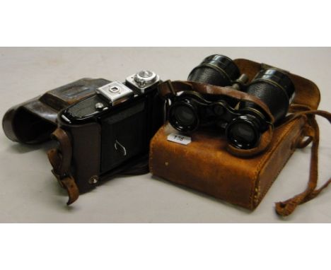 A leather cased Zeiss Ikon camera and a pair of binoculars.
