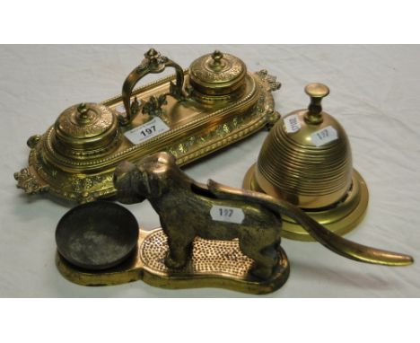 Embossed brass desk stand, desk bell and a dog nutcracker.