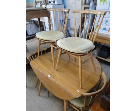 An Ercol light elm Windsor drop leaf dining table together with a set of 4 matching stickback chairs.