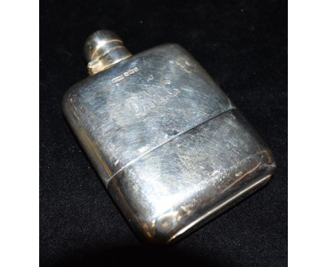 AN EDWARDIAN SILVER HIP FLASK the flask of plain form with engraved initials, the curved flask with detachable cup, measureme