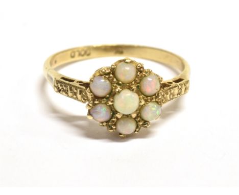 A VINTAGE OPAL FLOWER HEAD RING The flower head measuring 9mm in diameter, shank marked 9c gold, ring size R, weight 2g