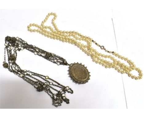 TWO ITEMS OF JEWELLERY Late 19th/early 20th century silver locket, the oval locket with chased floral front pattern, applied 