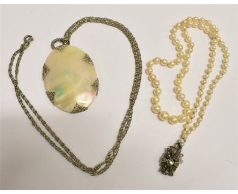 A VINTAGE CULTURED PEARL NECKLACE  with a mother of pearl pendant and chain, the cultured pearl necklace of graduated pearls 