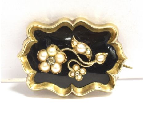 A VICTORIAN SEED PEARL AND ENAMEL MEMORIAL BROOCH the brooch in black enamel, featuring a floral seed pearl spray, with a cle