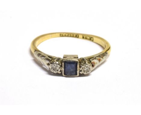 A VINTAGE 18CT GOLD PLATINUM DIAMOND AND SAPPHIRE DRESS RING The ring set with a central step cut sapphire on a platinum bed 