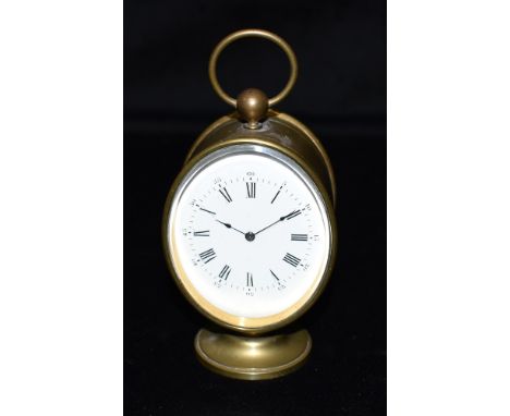 A SMALL FRENCH OVAL BRASS CASED MANTLE CLOCK  the enamel dial with Roman hour markers and Arabic minutes, 11cm high with carr