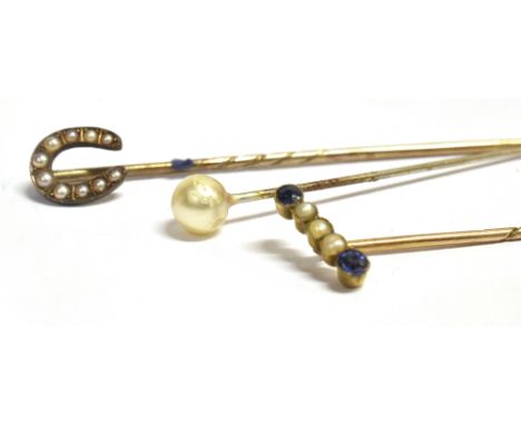 THREE VINTAGE STICK PINS to include a seed pearl and blue paste yellow metal stick pin (faded C T mark to spine)