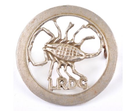 Long Range Desert Group Beret Badge, white metal example with scorpion to the centre and “LRDG” below. Two lug fittings to th