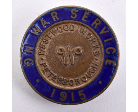 WW1 On War Service 1915 Westwood Works Peterborough Lapel Badge, gilt brass circular badge with blue enamel border. Thomas Fa