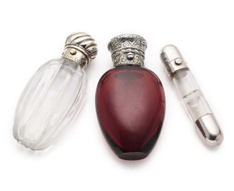 THREE VICTORIAN SILVER-MOUNTED SCENT FLASKS, ALL LONDON one with red glass ovoid body, the push button hinged top covered in 