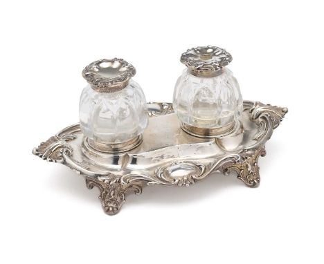 A VICTORIAN SILVER INKSTAND, HENRY WILKINSON & CO., SHEFFIELD, 1850 the shaped oval stand with leafy rim including two vacant