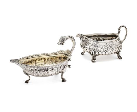 TWO ENGLISH SILVER SAUCEBOATS, BOTH LONDON one William IV oval example chased with flowering branches on a matted ground flan