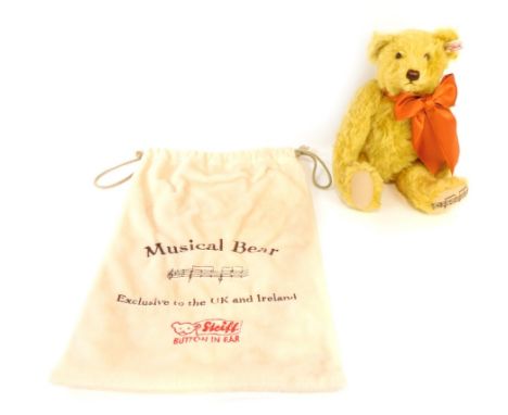 A Steiff musical bear, Exclusive to the UK and Ireland 26cm high, in cloth bag.