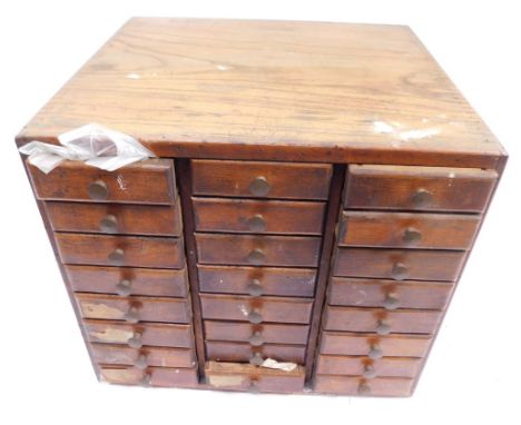 A wooden apprentice tool chest, with three rows of single drawers, containing a quantity of automobile screws and parts, 30cm