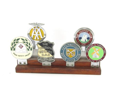 A car badge group, on two step plinth to include badges for AA, 589227, The Camping Club of Great Britain &amp; Ireland, Road