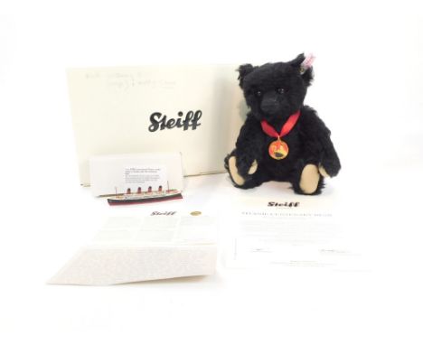 A Steiff Titanic centenary bear, black, 26cm high, with a small model of the Titanic, boxed with certificate.