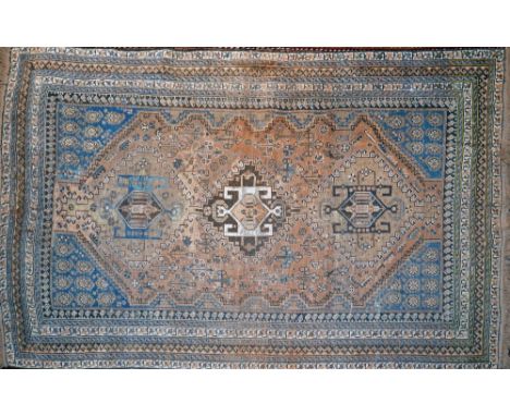 An antique Persian rug with triple geometric medallion, on a beige and blue ground, contained by many geometric borders, 189 