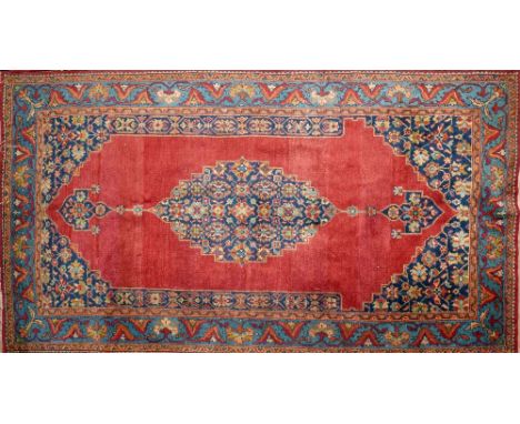 A 20th century Persian rug with central floral medallion, on a red ground, contained by floral borders, 210 x 114cm 