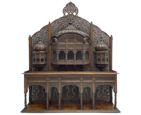 Late 19th century Indian Burmese carved and pierced hardwood and brass inlaid wall shelf, the shaped back profusely decorated