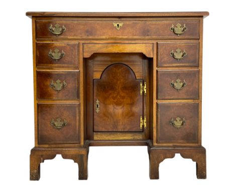 Georgian design figured walnut knee-hole desk, the rectangular moulded top with crossband, fitted with frieze drawer over six