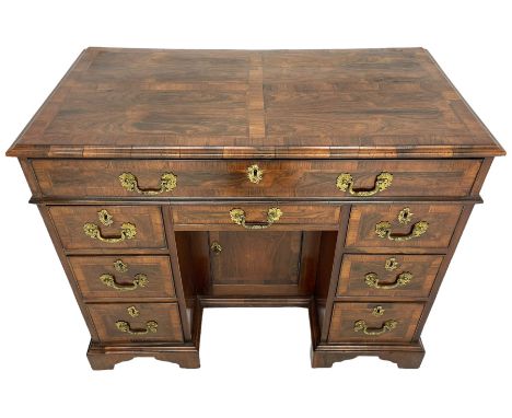 19th century George II design rosewood kneehole desk, the moulded top inlaid with book-matched rectangular panels with feathe