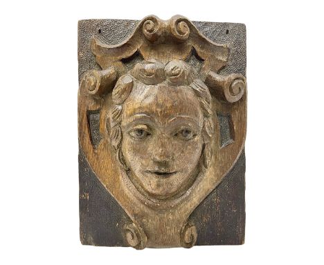 19th/20th century oak ecclesiastical wall plaque carved in relief depicting a portrait within a scrolling shield, H20cm, L15c