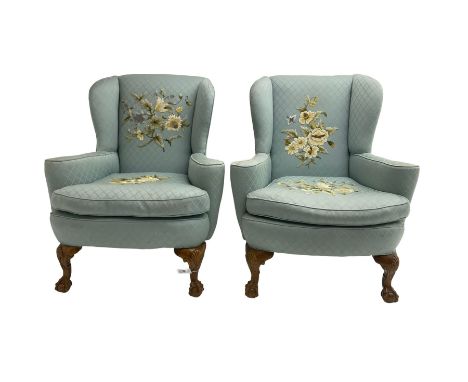 Pair of 20th century Queen Anne design stained beech framed wingback armchairs, upholstered in light blue fabric with raised 