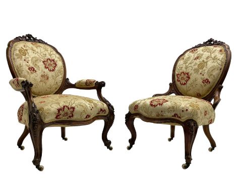 Pair of Victorian lady's and gentleman's walnut open armchair and nursing chair, shaped cresting rail carved with scrolls and