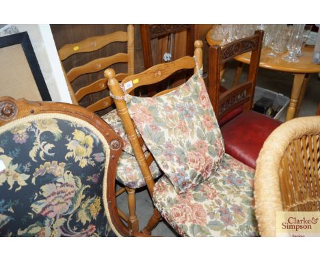A pair of ladder back dining chairs