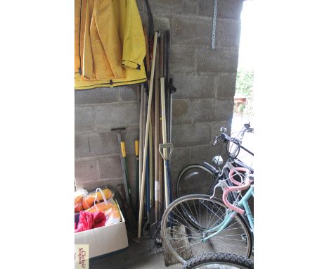 A quantity of long handled garden tools to include rakes, spades, forks, hoes, slashers etc. 