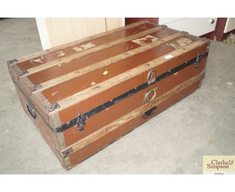 A wooden and metal bound travelling trunk