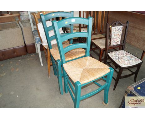 A pair of rush seated ladder back chairs