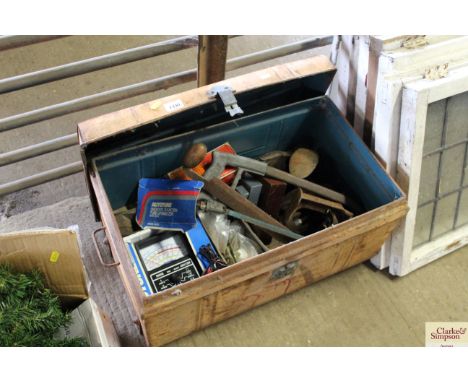 A metal trunk containing saws, shoe lasts, wood planes, diagnostic tune-up analyzer etc.