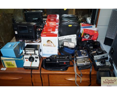 A quantity of various cameras to include Kodak; Fuji Film together with a slide viewer; a Canon compact photo printer etc