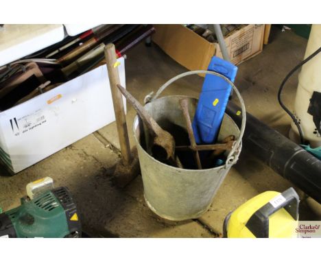 A galvanised bucket containing various tools to include impact driver, wheel brace, clamps, pick axe heads, roadside warning 