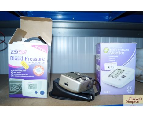 A blood pressure monitor together with another and a Boots camera