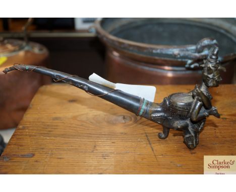 An Eastern figural decorated pipe
