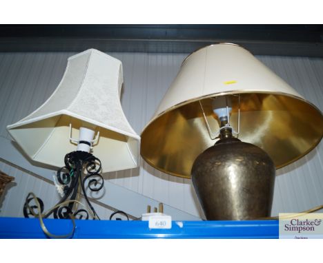 A brass table lamp and shade together with a wrought iron table lamp