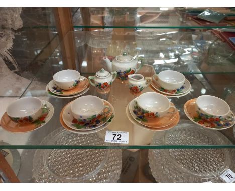 A 6 piece childs/miniature tea set including teapot and sugar and milk jug ( 2 side plates missing) 